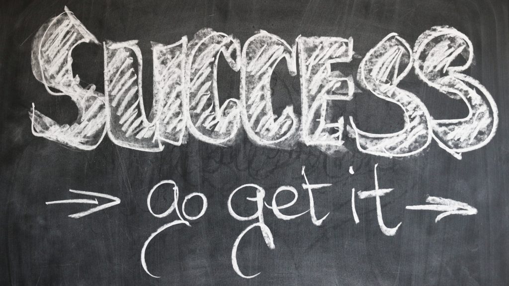 Blackboard with the message "Success - go get it" written in white chalk