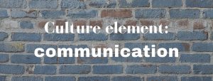 A blue-painted brick wall with the words 'Culture element: communication' superimposed in white