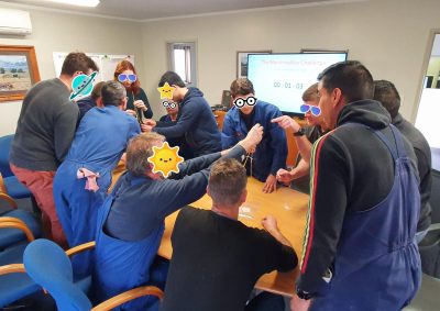A photo of people doing a workshop activity, with stickers over faces for privacy