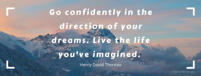 Text over a picture of mountains. Text says 'Go confidently in the direction of your dreams. Live the life you've imagined. Henry David Thoreau'