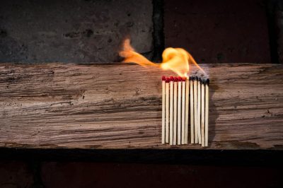 A row of matches on fire, buring from right to left