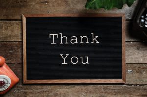 Black noticeboard with white writing saying 'Thank You'