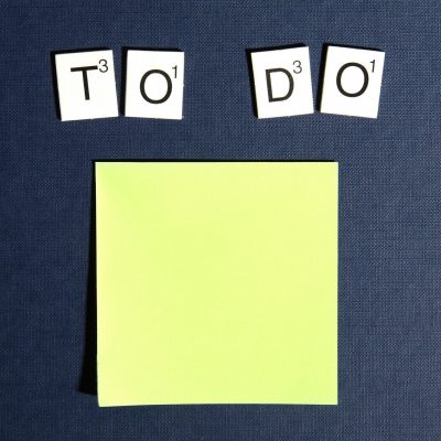 A yellow sticky note with the words 'to do' spelled out in Scrabble(TM) tiles
